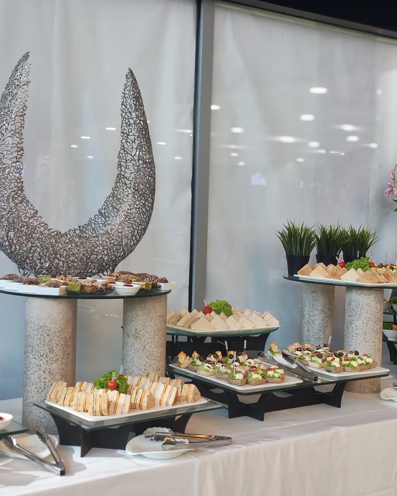 Hospitality buffet display with appetizers and decorative serving stands
