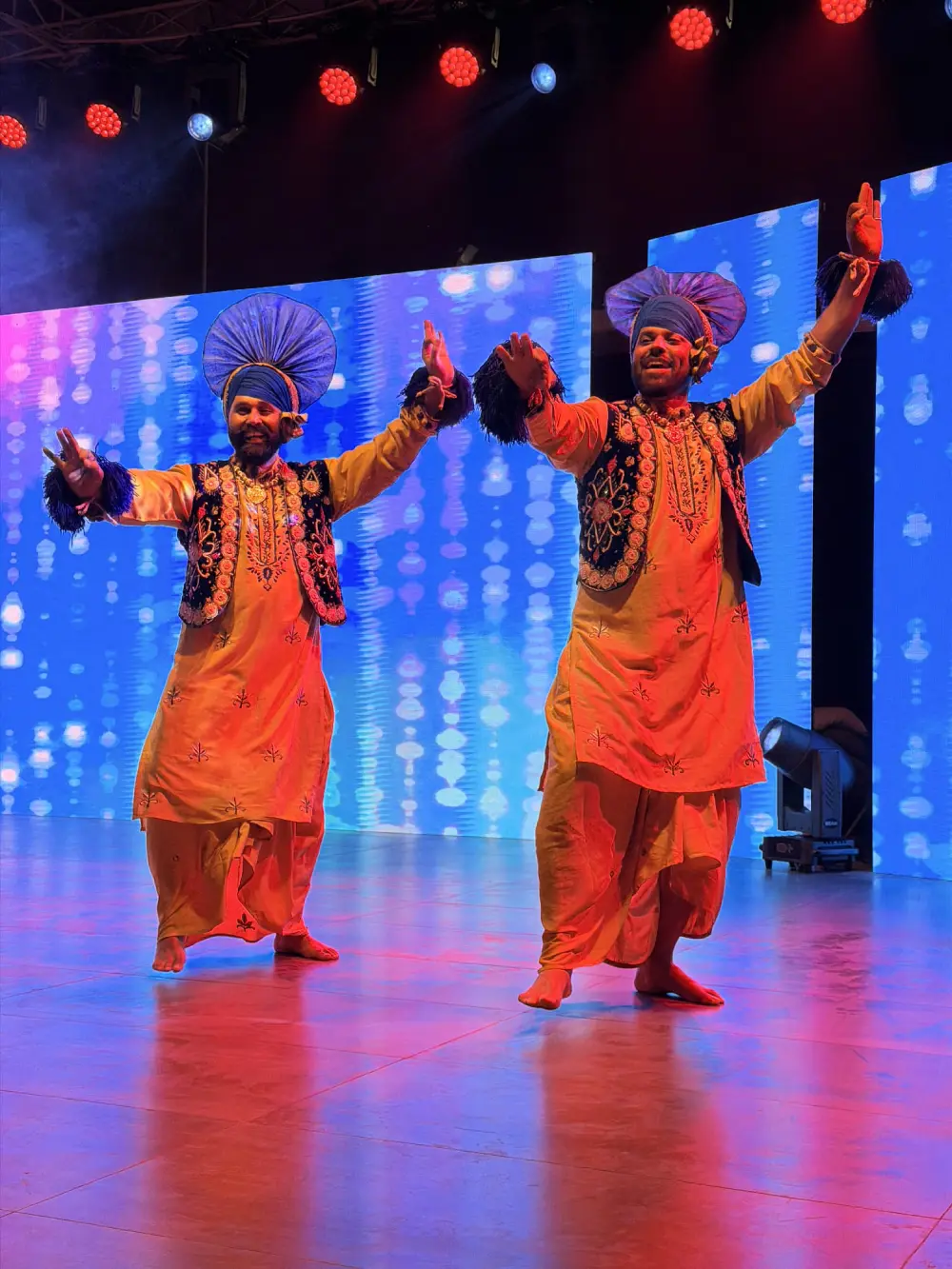 Live cultural performance with stage lighting