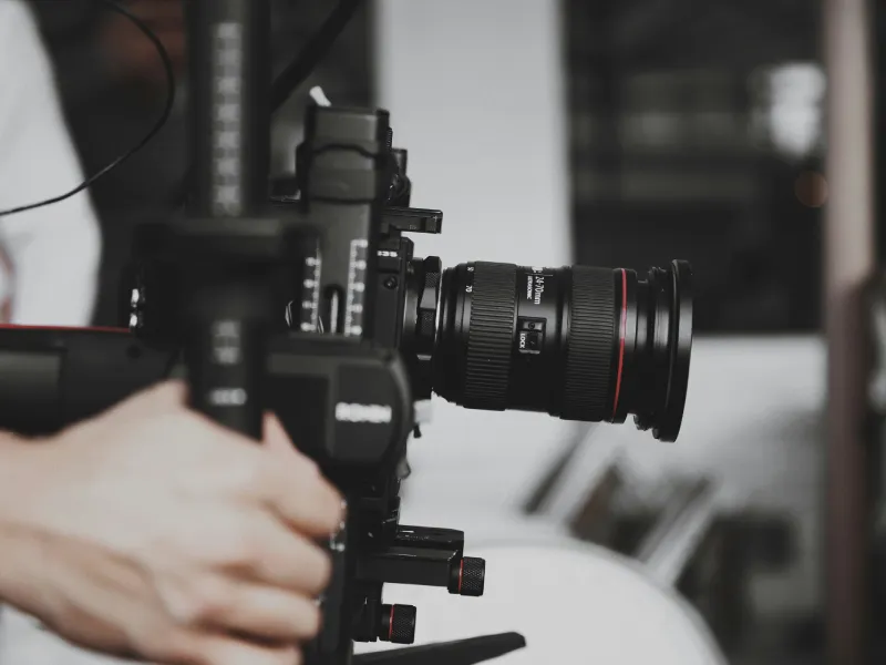 A camera mounted on a handheld stabilizer.